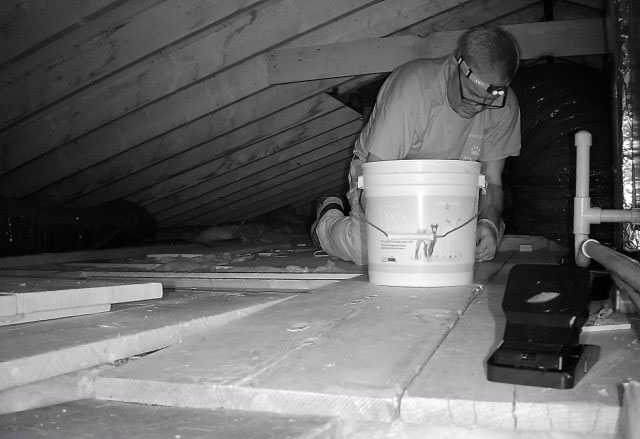 A black-and-white image of Dan setting mouse traps.