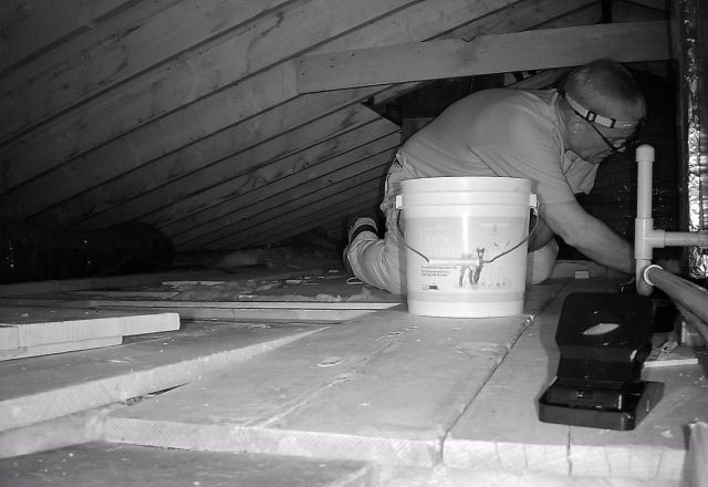 A black-and-white image of Dan setting mouse traps.
